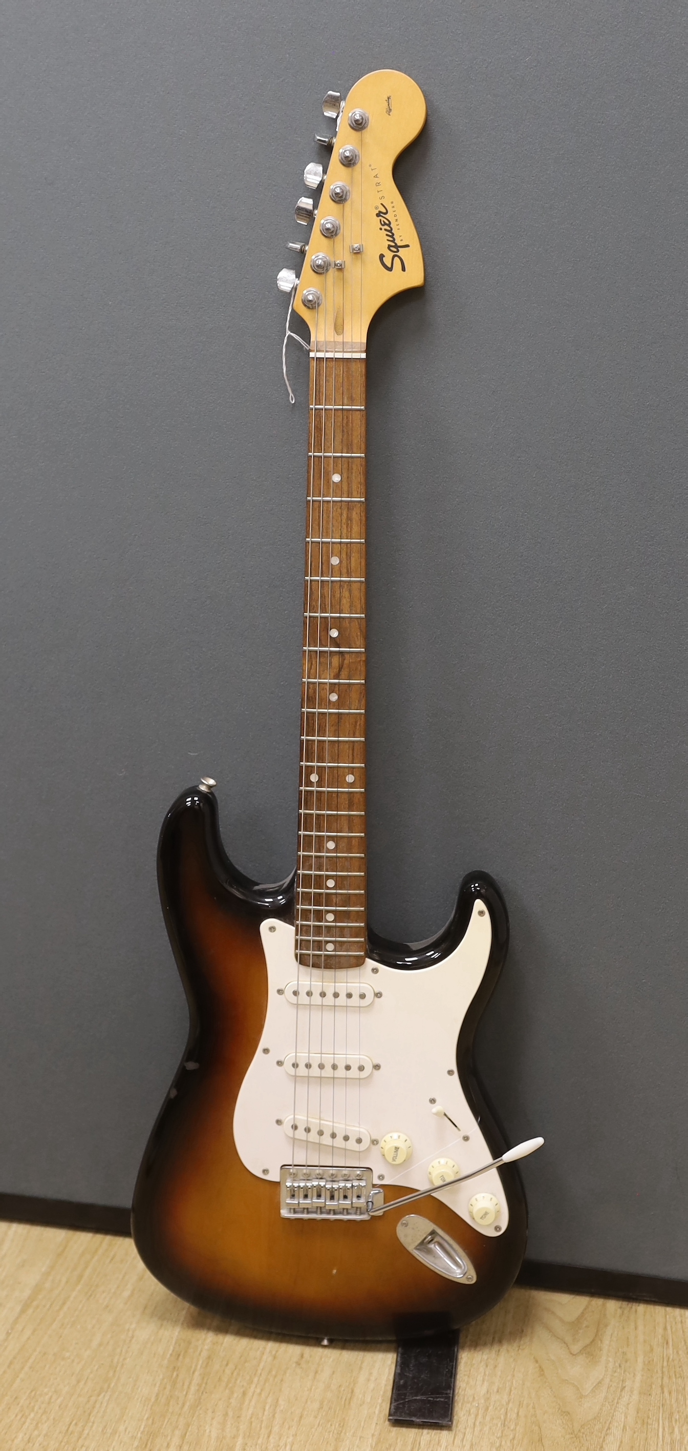 A Fender Squier 20th anniversary electric guitar with soft case